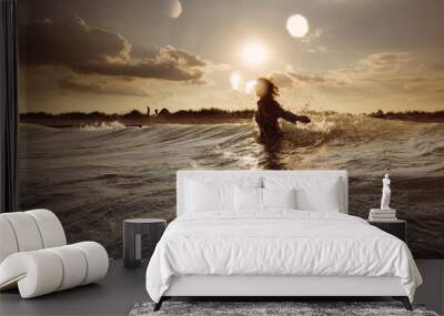 Young woman on sea embracing the the world and the waves Wall mural