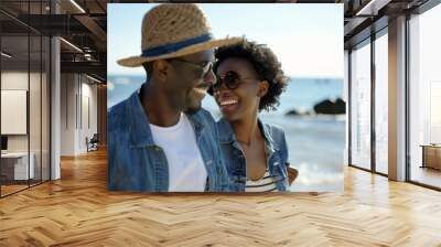 A smiling couple in casual denim attire shares a joyful moment by the sea. Concept of love, leisure, and coastal lifestyle. Wall mural