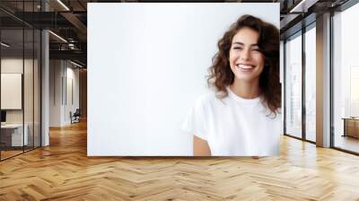 portrait of a beautiful young happy woman laughing. a smiling woman wearing white sweater standing and smiling on gray background with copy space. Wall mural