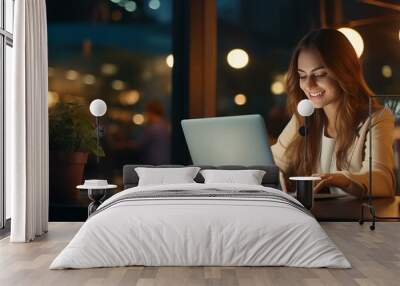 young professional woman working on laptop in the evening Wall mural