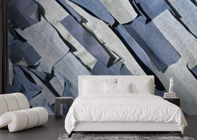 A pile of shredded raw denim fabric in a denim factory. Industrial fabric and fashion manufacture. Stylish blue denim fabric for wholesale and jean recycling. Wall mural