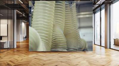 Plastic ribbed air conditioning airflow pipes and tubing sucking dust and industrial particles out of wood and metal cutting machines. Keeping the air and workplace clean and free from pollution Wall mural