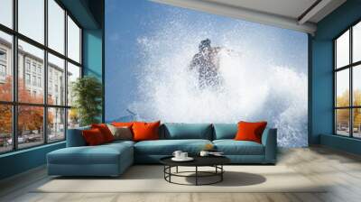 Person surfing in the ocean on a sunny day Wall mural