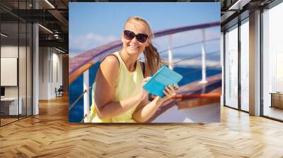 Happy woman with pad during sea traveling Wall mural