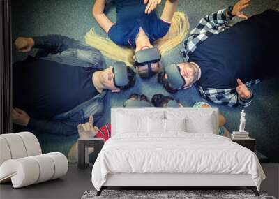 Multiracial group of friends playing on vr glasses indoor - Virtual reality concept with young people having fun together connecting with headset goggles. Digital generation trends Wall mural