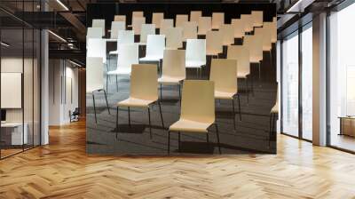 Group of white chairs arranged for social distance, ready to sit visitors in indoor business event. COVID-19 health and safety measures during pandemic requires spacing between people Wall mural