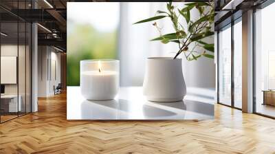 A scented candle on a white table with plant on a modern minimalist background Wall mural