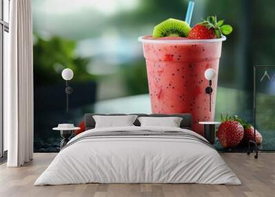 High-resolution image of a strawberry kiwi smoothie in a clear cup, with condensation, against a sleek, cool backdrop Wall mural