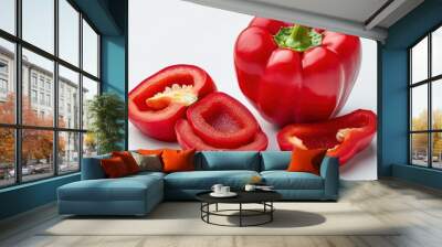 Whole red bell pepper and a few cut slices, bright and shiny on white background Wall mural