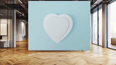 White heart shape isolated on pastel blue background .Empty space for text , message Wall mural