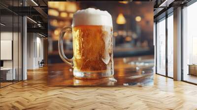 Cold beer A close-up view of steamed mug with foam overflowing in a bar on wooden table a desk Wall mural