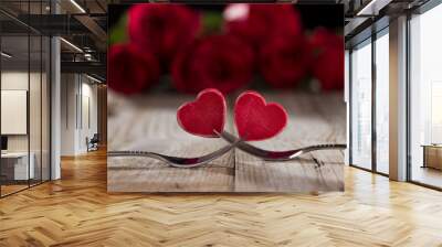 Two hearts between two forks on a table, close up Wall mural