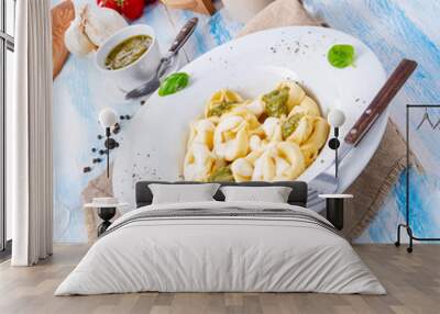 Tortellini di formaggio with basil pesto and cheese sauce Wall mural