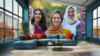 A group of women from different religions smiling together. Wall mural