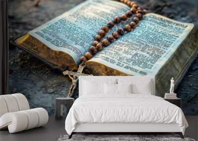 A rosary lying on an open Bible. Wall mural