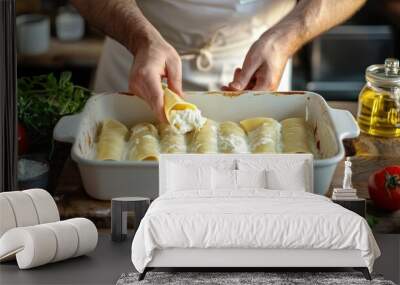 Chef filling cannelloni pasta tubes with ricotta cheese and placing them in a baking dish. Wall mural