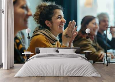 Group of attendees exchanging smiles and friendly gestures during a seminar on personal growth. Wall mural