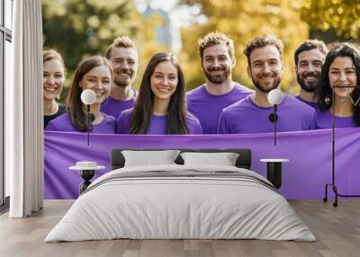 Group of people wearing purple shirts and ribbons, holding a banner to raise awareness for World Brain Tumor Day. Wall mural