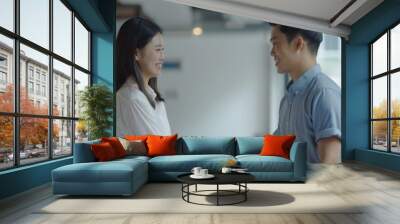 Interviewer shaking hands with an Asian job candidate. Wall mural