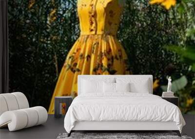 Yellow dress with floral patterns in a garden setting, creating a cheerful and elegant look. Wall mural