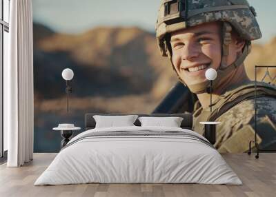 A young male soldier in desert combat gear smiles confidently during a military operation in a desert environment, holding a rifle. Wall mural