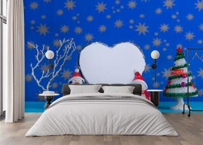 Creative layout with christmas decorative figurines holding blank heart shape card for text Wall mural