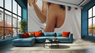 A woman smiles at her reflection while brushing her teeth in a modern bathroom, showing joy Wall mural