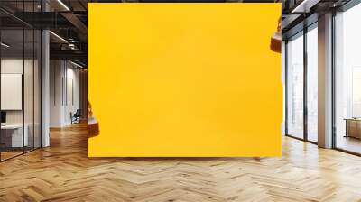 Luxury chocolate bars on a vibrant yellow background with copy space Wall mural