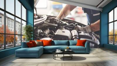 Experienced mechanic meticulously repairing car engine in top notch auto repair workshop Wall mural