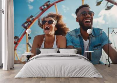 fun entertainment in an amusement park for people who want to throw out their emotions. happy cheerful black couple laughs and screams on the rides Wall mural