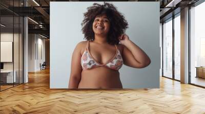 Love my body. Plump, plus size african american woman in underwear laughing, lifting her arm up over grey background. Concept of acceptance , body positive, equality Wall mural