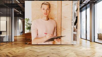 Man stands in the office with documents Wall mural