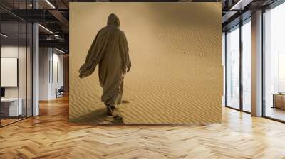 Man walking in sand following god  religious concept photography for spiritual inspiration Wall mural