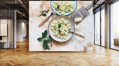 Italian homemade gnocchi with butter, cheese and sage served in two plates on a light marble table. Italian food. Copy space. Flat lay Wall mural