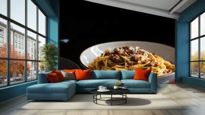 Traditional Italian pasta spaghetti bolognese served on a dark table with a black background. Classic meal of global world cuisine Wall mural