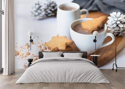 Two white cups with hot chocolate or cocoa drink with Christmas tree shape cookie on a wooden board and light marble background with festive winter decorations. Winter mood. Close up. Selective focus  Wall mural