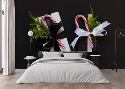 Two Christmas presents with candy canes on black backgounds Wall mural