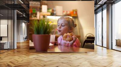  little  girl sitting in    cafe Wall mural