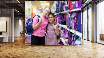 middle school girls choosing   briefcase in   store. Wall mural