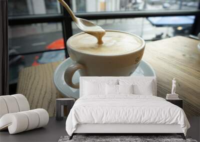 A cup of cappuccino with milk Wall mural