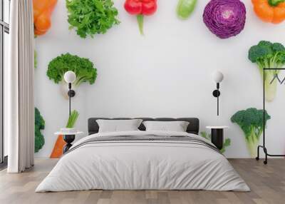 Colorful vegetables arranged around a white background, perfect for a healthy food or recipe concept. Wall mural