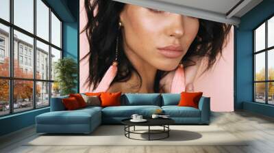 beautiful young woman with dark hair and glowing skin posing in studio Wall mural