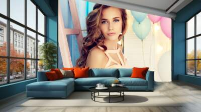 fashion interior photo of beautiful young girl with dark curly hair and tender makeup, posing with c Wall mural