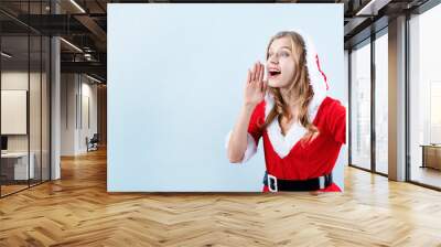 closeup of caucasian happy woman wearing santa clothes calling someone Wall mural