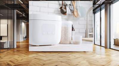 Electric rice cooker on wooden counter-top in the kitchen Wall mural