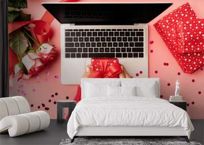 Female hands holding a red valentine gift box top view on pink background Wall mural