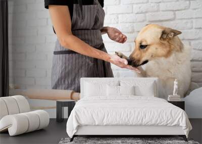 Woman kneading dough at home Wall mural