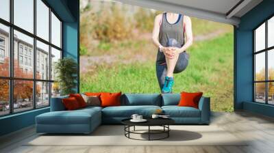 Active fitness woman stretching outdoor. Healthy lifestyle concept Wall mural