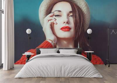 Young beautiful hipster girl in red jersey with hat Wall mural