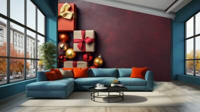 Top view of gifts, bows and Christmas decorations on a dark maroon background Wall mural